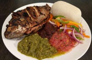 BANKU AND WHOLE GRILLED TILAPIA WITH GREEN SAUCE.